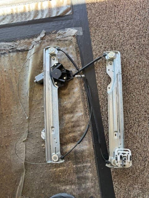 Automotive power window regulator assembly removed during repair