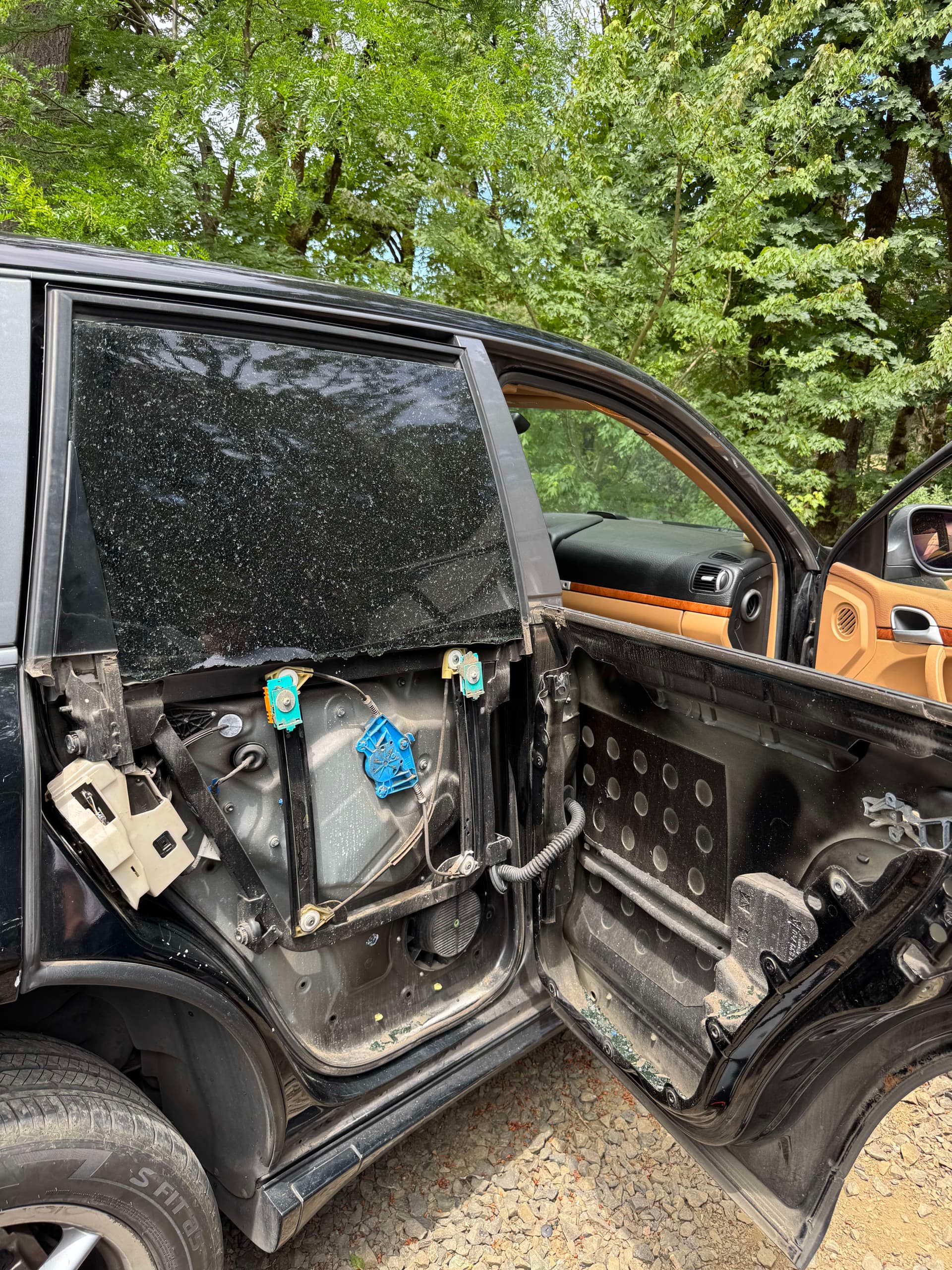 Shattered pickup truck door window taped before auto glass replacement