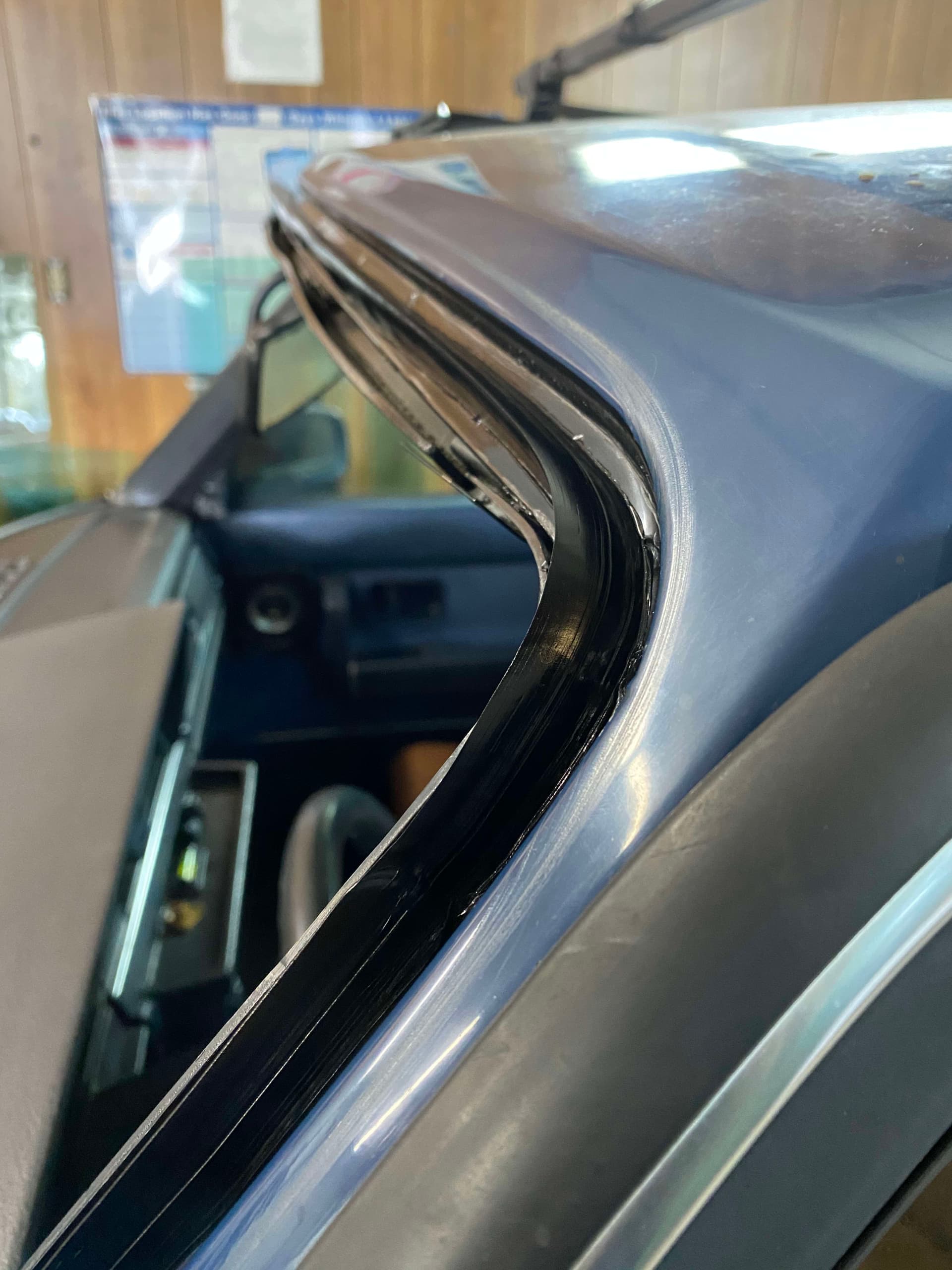 Close-up of a windshield being set with a professional tool