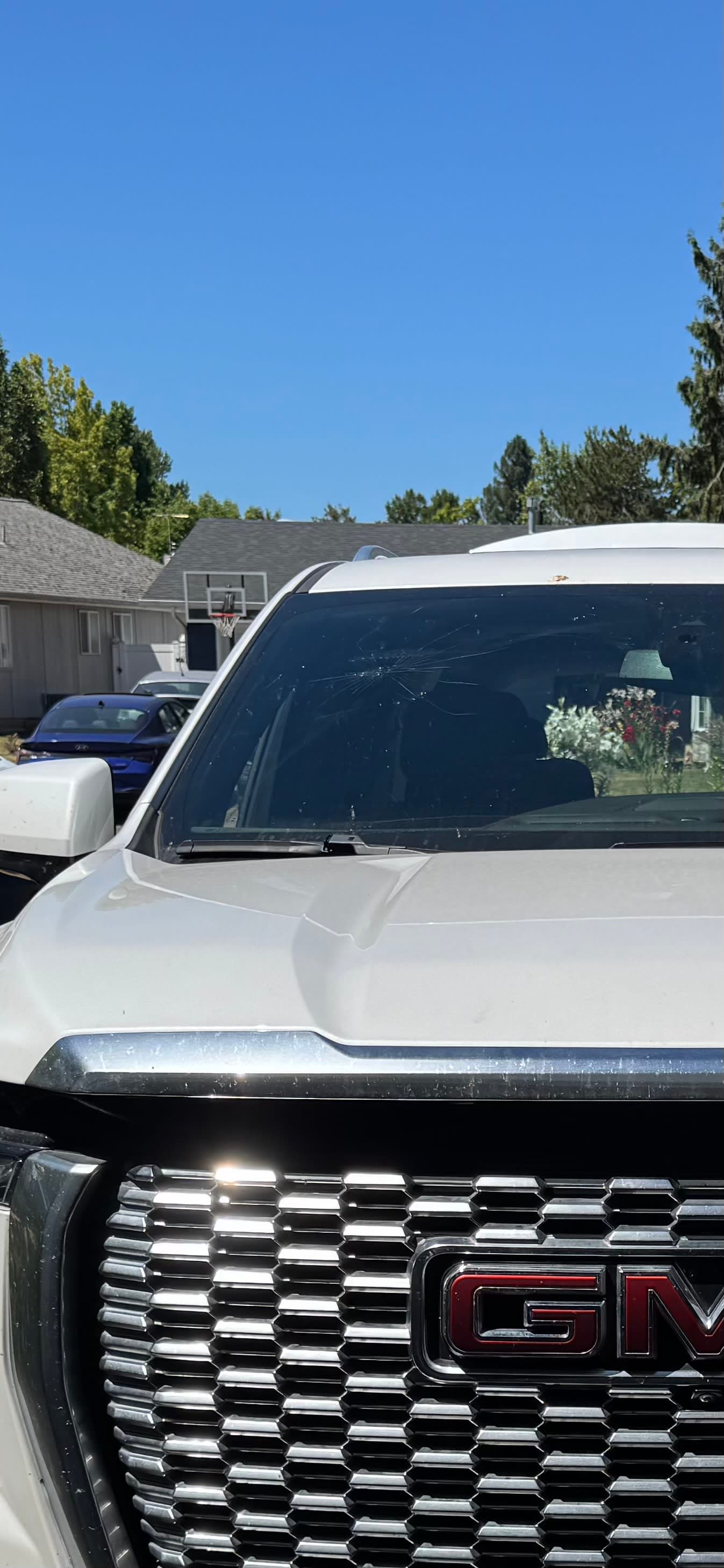 broken windshield, huge impact fracture spreading across entire windshield