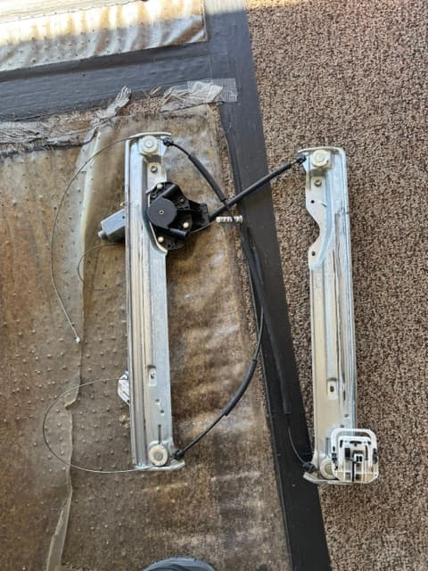 Automotive power window regulator assembly removed during repair