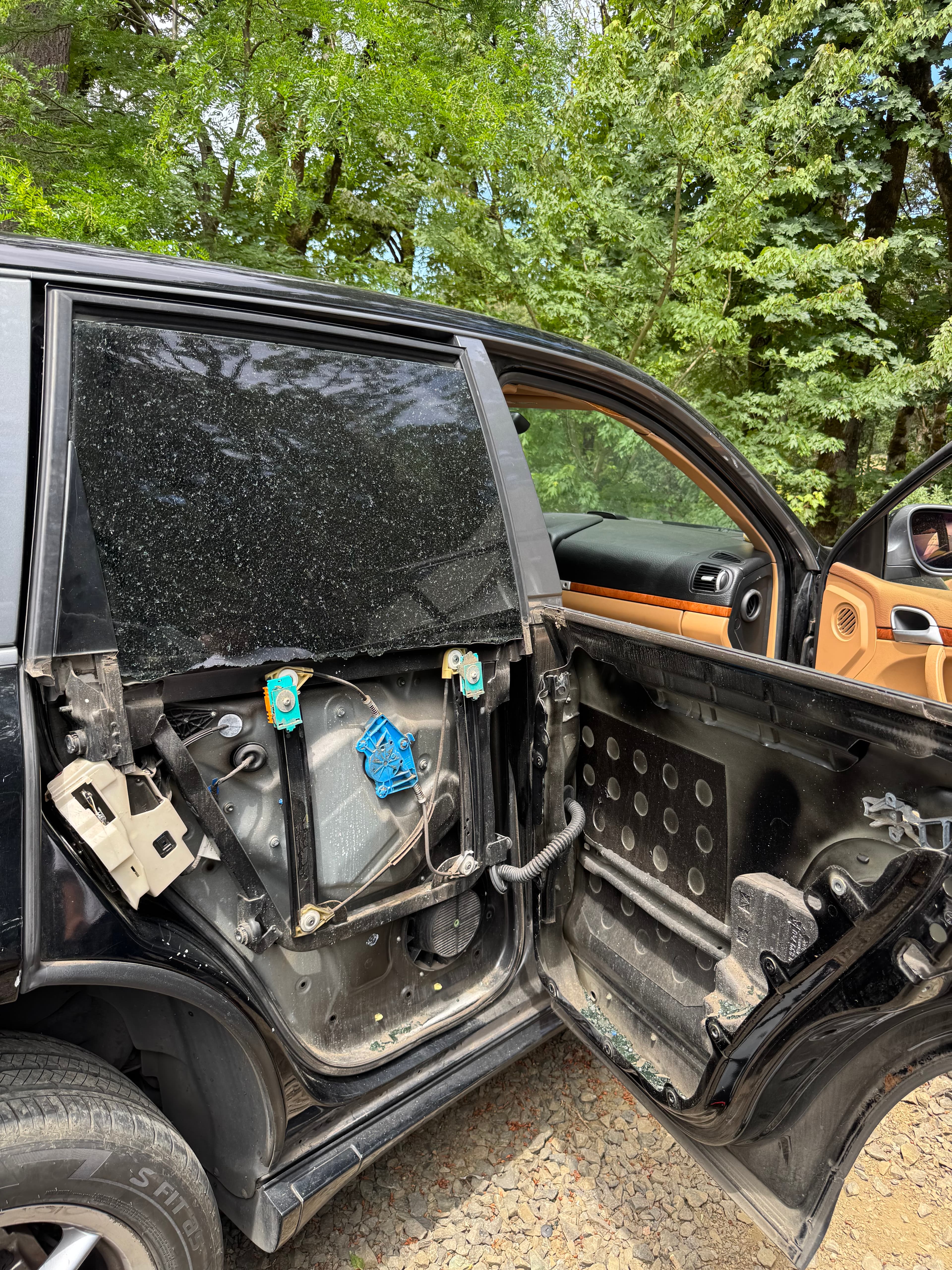 Shattered pickup truck door window taped before auto glass replacement