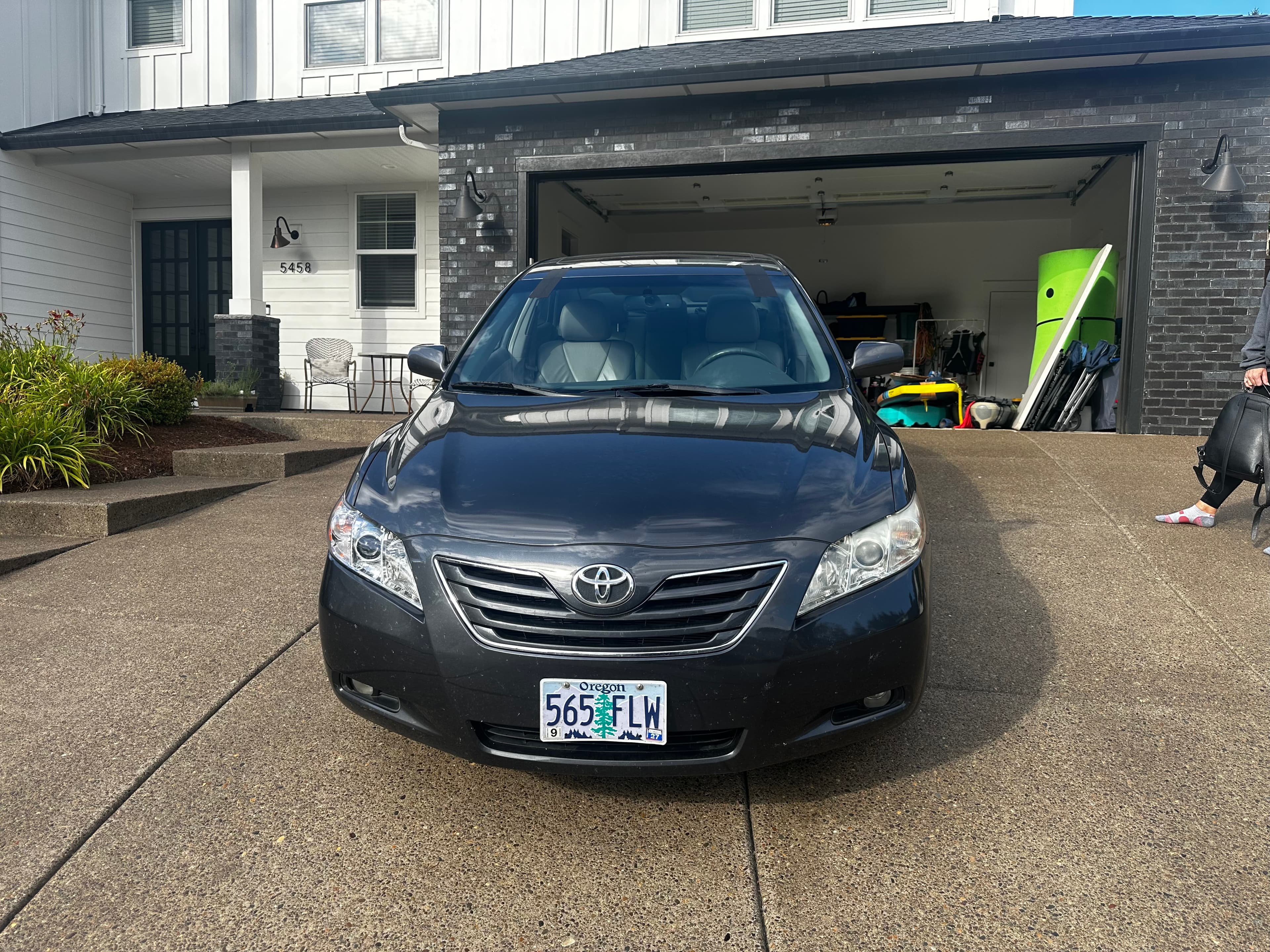 Clean finished windshield on a black Toyota Camry in a driveway